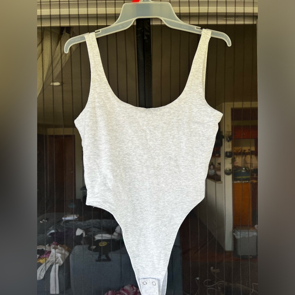 GARAGE, size SMALL. Backless Body suit. Buttery smooth material Grayish white